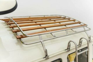 Restored Volkswagen T2 Camper with roof baggage racks for extra storage space on long trips.